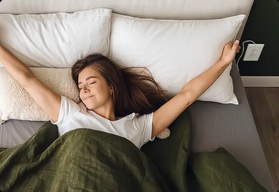 Official lifestyle image of a sleeper resting on Velin Grounding Bed Sheets