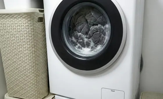 Seller image of the Velin weighted blanket beside a washing machine